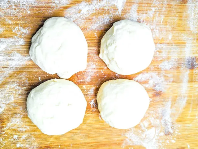 Dough rolled out to balls in preparation for rolling.